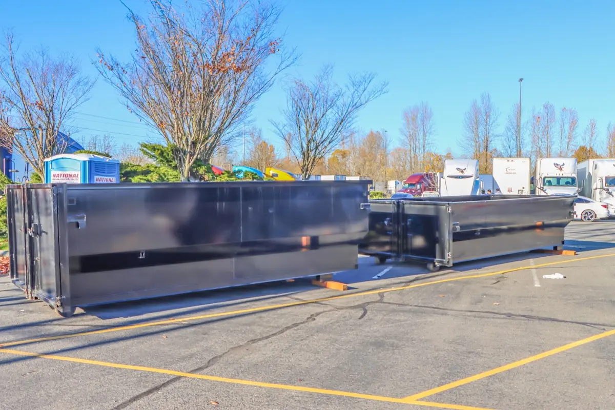 Professional dumpster rental service with roll-off container on residential driveway in Delphos